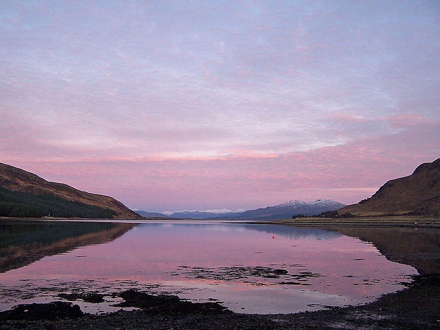 Evening over Caolas Scalpay Viewed from Strollamus. On the left is the tip of the island of Scalpay. On the right is the lower slopes of Creag Strollamus. The snow covered mountains in the distance are on the mainland.