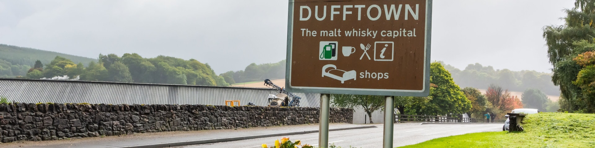 A welcome sign for Dufftown, indicating it's the malt whisky capital, with a speed limit sign of 40.
