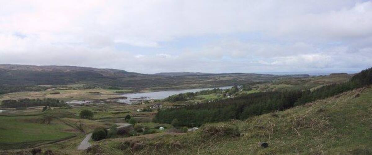 A river winding through a valley with hills in the background.