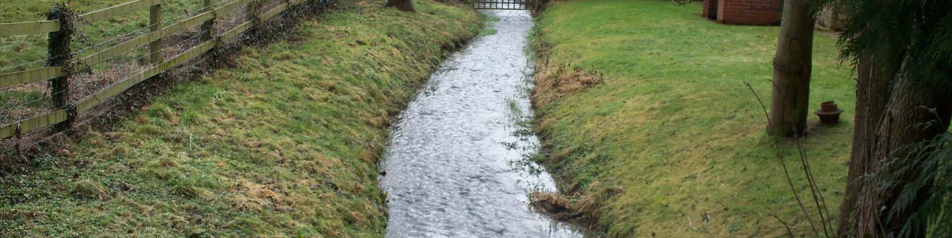 River Windrush The infant River Windrush flows under the road at Ford.