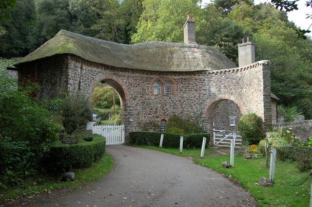 Gated entrance to the Worthy Combe Toll Road. Drivers need to ring the bell before someone comes out to open the gate. The present fee is £1. The smaller gate on the right is part of the coastal footpath and is free.