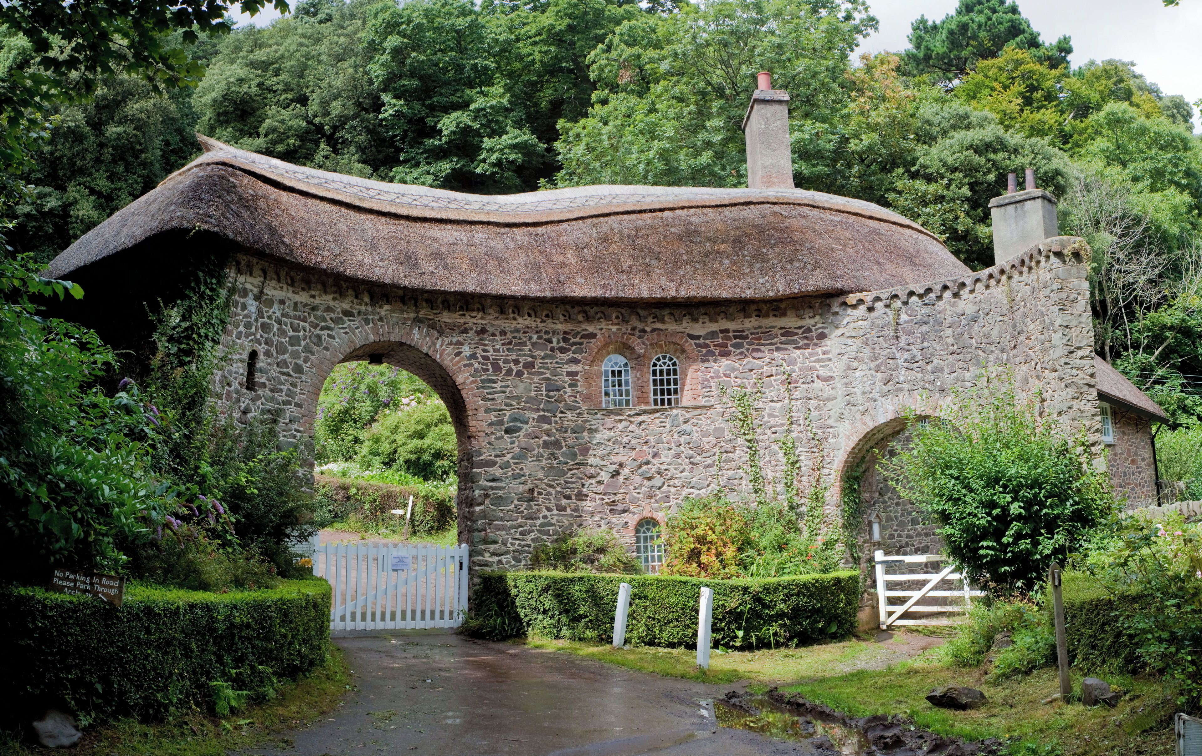 A stone house with a curved roof and arched windows.