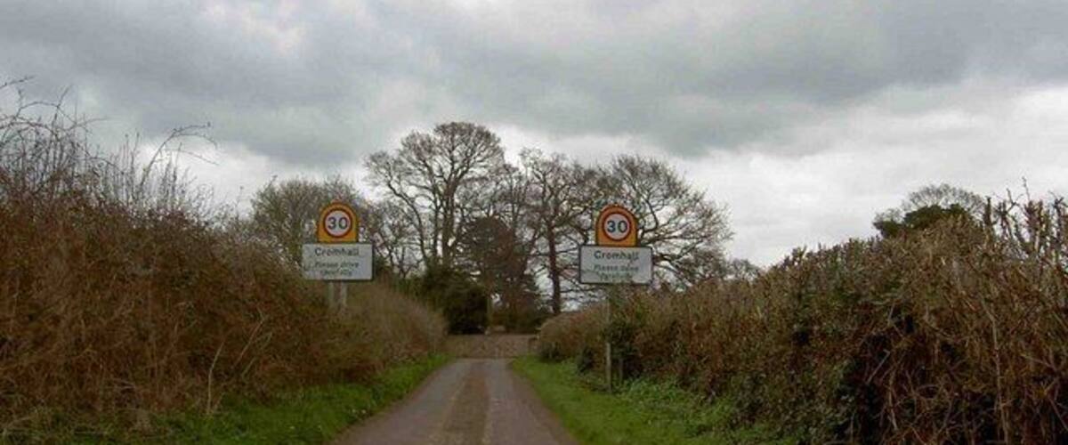 A rural road with speed limit signs indicating 30 mph.
