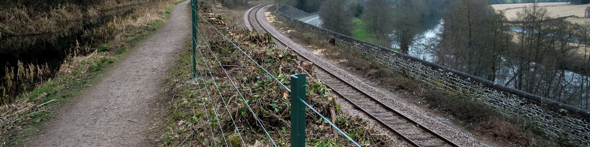 Looking South along the Cromford Canal, about 1km South of Whatstandwell. The picture clearly shows the four forms of transport along this section of the valley, from left to right: the canal and its towpath, railway line, road (the A6) and the river Derwent.