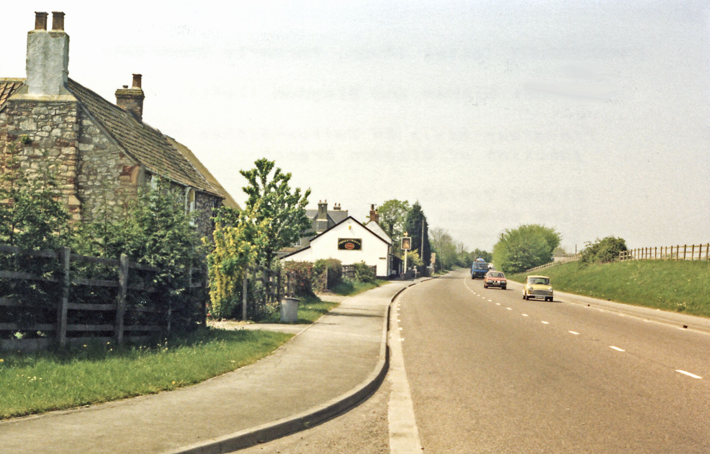Westward on A370 out of Congresbury past site of station, 1987. The road, going towards Weston-super Mare, used to cross the ex-Great Western branch line from Yatton (to right) to Wells and Witham (to left). The station and line were closed to passengers 9/9/63, to goods 1/10/64; also a branch ran to Blagdon from Congresbury until 14/9/31 (passengers, goods 1/11/50).