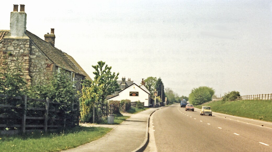 Westward on A370 out of Congresbury past site of station, 1987. The road, going towards Weston-super Mare, used to cross the ex-Great Western branch line from Yatton (to right) to Wells and Witham (to left). The station and line were closed to passengers 9/9/63, to goods 1/10/64; also a branch ran to Blagdon from Congresbury until 14/9/31 (passengers, goods 1/11/50).