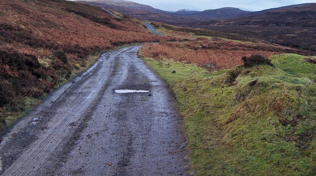 Track from Fasach A well made track leads from the end of the road in Lower Fasach to an isolated building on the moor. In the background is a misty and snow capped Healabhal Mhòr in grid square NG1851.