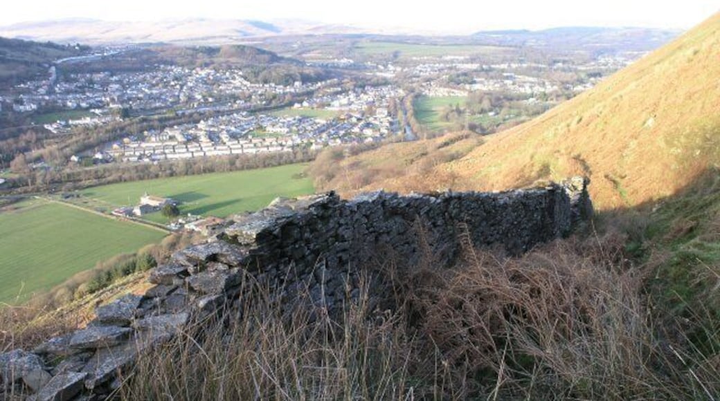 Dry stone wall above Ystalyfera This dry stone wall is on a little used section of St Illtyd's Walk above Ystalyfera. Rather than protecting the footpath, over the years a buildup of stones combined with retention of water has made the footpath very difficult to walk on.