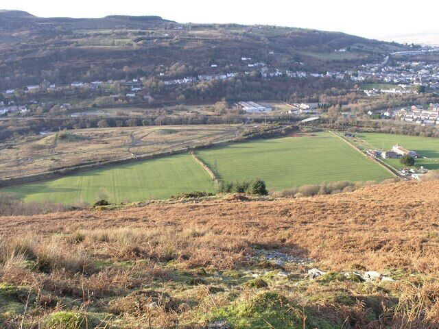Swansea valley from Darren Fach A good view of most of this square from Darren Fach. You can clearly see the course of the old Swansea to Brynaman branch run diagonally through the picture. This is now part of the Sustrans cycle path network. What's less easy to see (but it's there if you look carefully) is evidence that there was once a railway junction right in the centre of the picture. Look very carefully at the fields to the right and you'll see a slight raised line run through them. This in fact is the original junction and course for the Vale of Swansea line to Brecon.