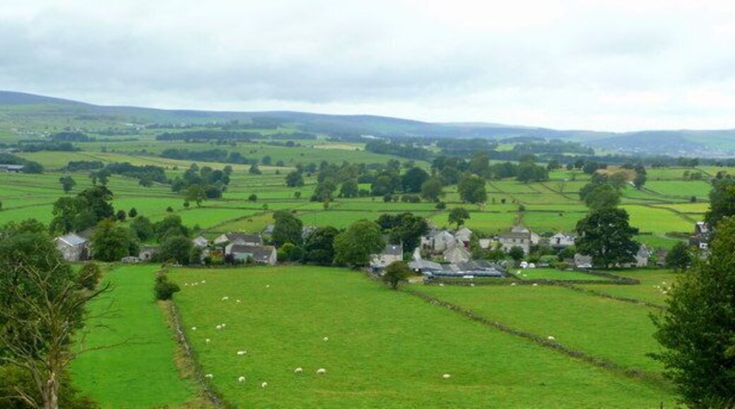 View of Chelmorton Townend Showing the parallel fields of un-enclosed land. The landscape around Chelmorton is of historic importance in that evidence of medieval pre enclosure or strip farming has been preserved. Cultivation took place in usually huge open fields surrounding a village and each villager owned a number of strips in each field. This open field system meant that every operation must be conducted in common by all villagers, and no one could produce crops at a different time or that which required different treatment from its neighbours. Changes in agricultural practices from the 16th century onwards led to the disappearance of the open system and increased prosperity changed the mediaeval village beyond recognition. Except at Chelmorton, where the land was considered of such a poor quality, that enclosure was not considered worthwhile and so the field pattern has remained untouched.