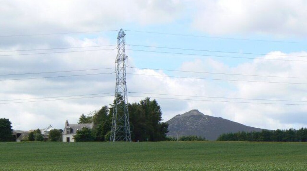 Pylon by the farm West Balquhain Farm with Mither Tap on Bennachie in the background.
