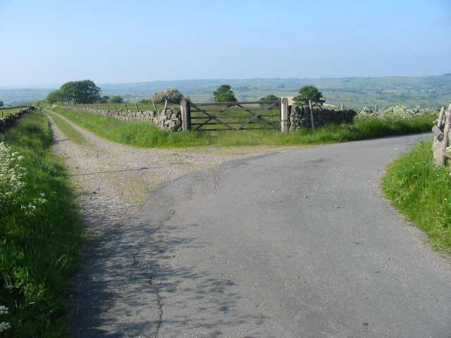 Track to Broomyshaw The road on the right is Duke's Lane leading down to Broomyshaw. The track on the left heads towards Ballamont Grange. At the bottom of Duke's Lane is a disused railway line that would once have been used to take limestone from the massive Cauldonlow quarry which is just to the east of this point.