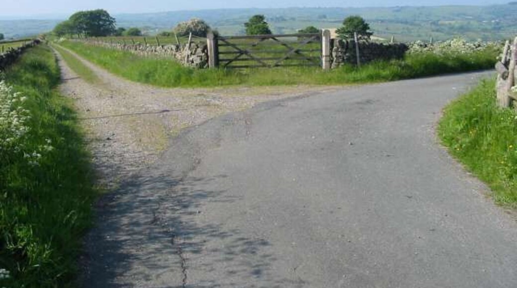 Track to Broomyshaw The road on the right is Duke's Lane leading down to Broomyshaw. The track on the left heads towards Ballamont Grange. At the bottom of Duke's Lane is a disused railway line that would once have been used to take limestone from the massive Cauldonlow quarry which is just to the east of this point.