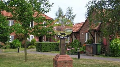 Village sign, Catfield. "This sign was unveiled by John Francis from Anglia Television on 14 September 1998". As well as 197397, a tractor and a trading wherry (see TG2508), the sign depicts a cat and, at the top, the local rare species, a swallowtail butterfly. The wherry is significant because the village has two staithes, one on the Ant in TG3620 and one on the Thurne TG3921 - just over 2 miles as the crow flies, not much more by road, but a tortuous 14 miles or more by river. Apparently the village used to be known as "Clever Catfield" for this reason.