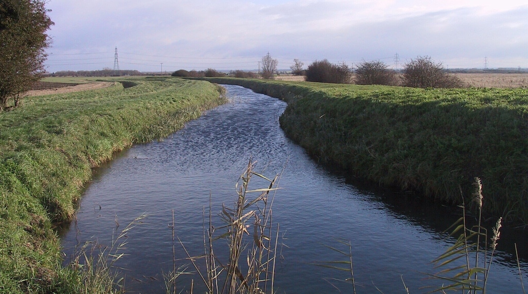 New River New River flows from Exning, through Landwade, Burwell, Fordham and Wicken, where it becomes Monk's Lode, which joins to Wicken Lode. This photograph was taken from the Wicken footbridge, close to where it becomes Monk's Lode. This is the fen-edge, on the right is Guinea Hall Fen (part of the Wicken Fen National Trust National Nature Reserve) and to the left is Wicken village, which is slightly uphill.