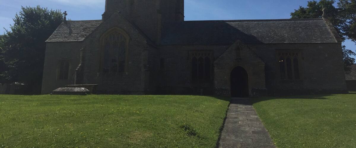 A church with a tall tower and a clock.