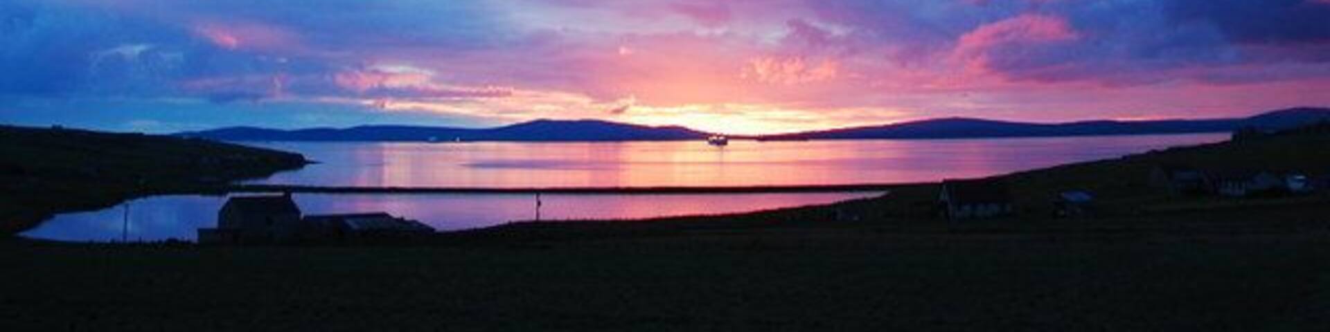 Echna Loch Sunset The view from my living room window. Echna Loch with Scapa Flow beyond.
