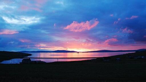 Echna Loch Sunset The view from my living room window. Echna Loch with Scapa Flow beyond.
