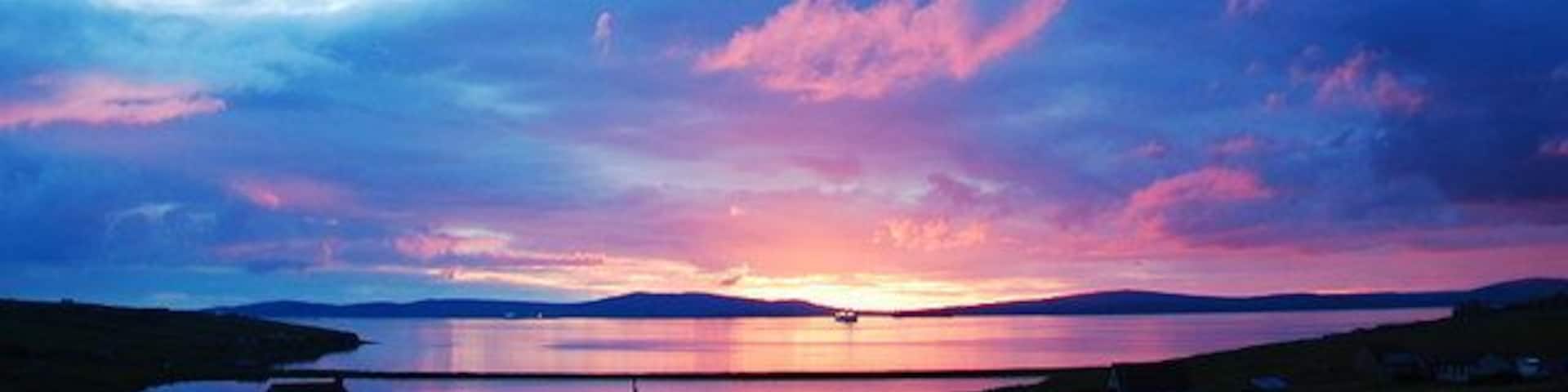 Echna Loch Sunset The view from my living room window. Echna Loch with Scapa Flow beyond.