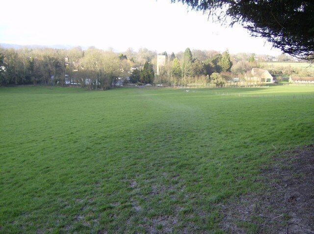 Approaching Buriton The footpath leaves the woods and descends more gently towards Buriton, the church being on the corner of four squares, the pond to its left being partly in SU7319.