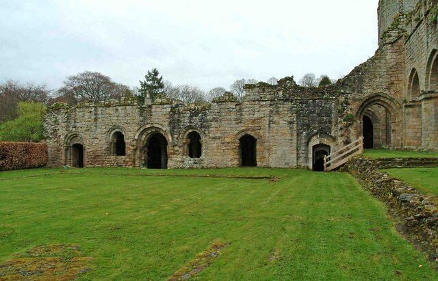 Buildings at Buildwas Abbey This range of buildings has survived, probably because they are still rooved. The arch in the middle with windows on both sides is the Chapter House. The arch by the wooden stairs gives access to The Crypt, which is now open to the public.