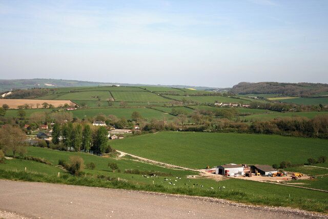 Court Farm Looking towards Court Farm and farm buildings in the valley near Buckland Newton from Revels Hill road junction.