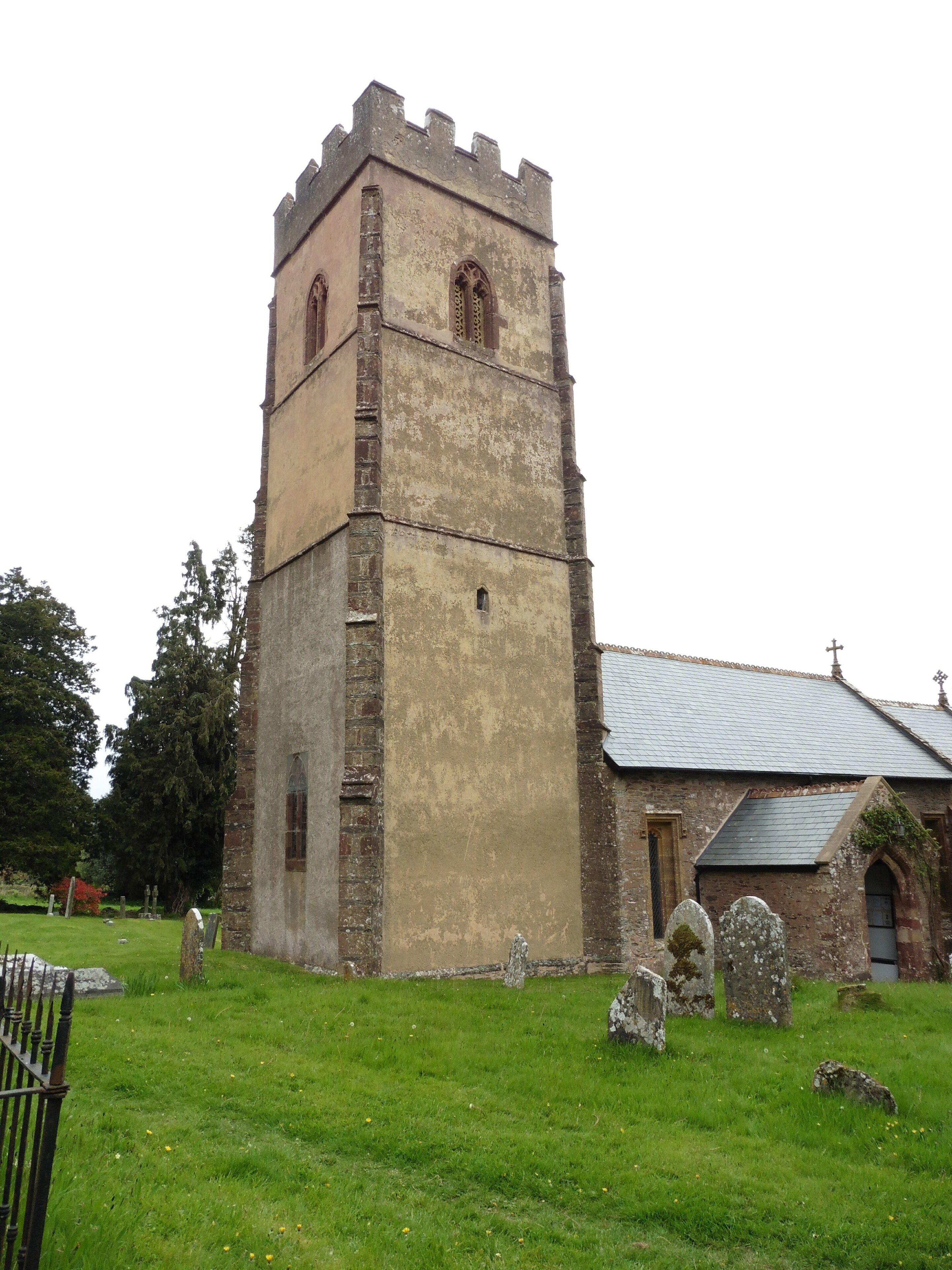 An old church with a tower and a graveyard.