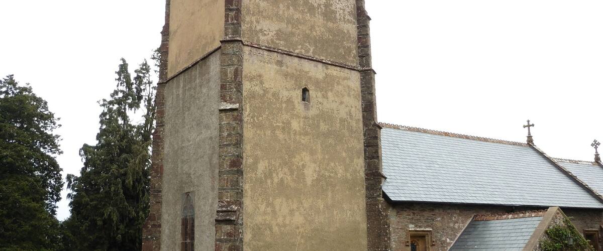 An old church with a tower and a graveyard.