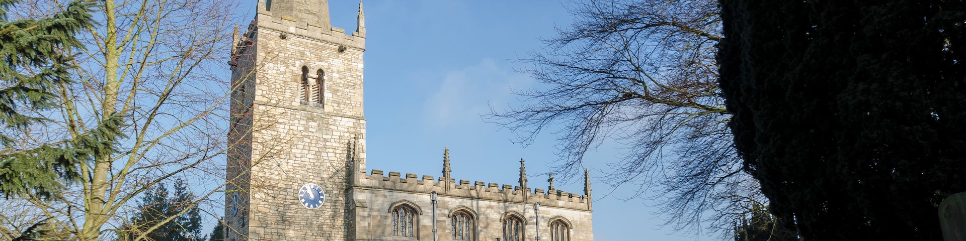 Originally an 11th C. church with west tower from 11th and 12th C. 13th century font and inner south doorway, 14th century south aisle and south porch, 15th century seating and chancel plus new nave roof and clerestory, tower parapet and spire. 1864-1875 saw new north aisle, outer wall of porch removed and rebuilt, porch roof repaired, pipe heating installed, all floors and seating removed and redone and the gallery which had partially blocked the tower arch and accommodated the choir was removed. 1888 the church clock was installed. 1893 Chancel alterations and organ installed built by Henry Willis & Sons Ltd. 1895 Restoration of belfry and spire, spire taken down as unsafe – the stones were numbered and replaced in original position at cost of £324. 1912-13 New roof to south aisle and porch and extensive repairs to nave roof plus vital work to the tower at cost of £740. 1962 On Christmas day it is believed that a mouse chewed through an electricity cable which caused a devastating fire destroying the chancel and organ (fire believed to have originated in the organ), causing much smoke damage in the rest of the church which can still be seen on the arches and the cross which buckled in the fire is on display in the church. 1966 The church was rededicated with new chancel, new east end stained glass window and new organ built by Messrs Cousans (Lincoln) Ltd. The total cost was £44,000 (of which £35,000 was paid for through insurance). 2011 After numerous lead thefts from roof, a new roof is being installed at a cost of £35,000 made of terne coated steel with no resale value.