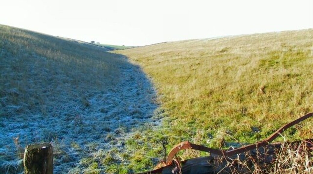 Shuttle Rake. Even at noon, the frozen ground on the north-facing slope of the depression remains untouched by the sun. Looking west up Shuttle Rake towards the old open cast workings.