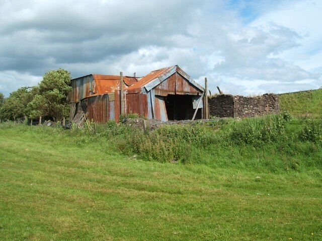 First Sight This is the first 'building' that anyone sees, coming off the A9 slip road for Greenloaning. It is from a slightly different angle though. The original stonework is nearer the slip road. The corrugated iron building defies any description. It does though, have a certain quaintness. It backs on to grazing land, but there were no animals near on this afternoon.