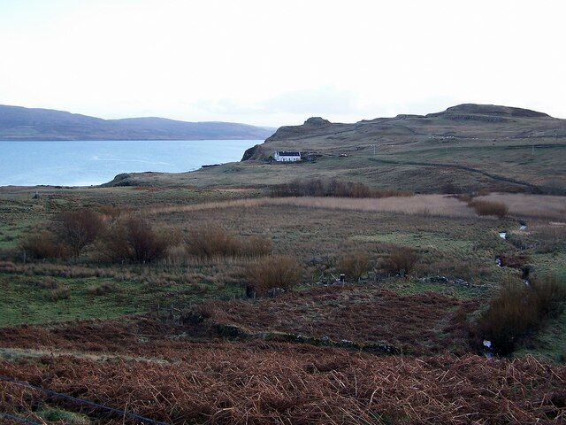 Abandoned land at Borreraig This view looks over uncultivated land in Borreriag, part of which has at one time been enclosed by a stone wall. The 'lump' on the headland behind the white house is Dùn Boreraig Broch. The water is Loch Dunvegan.