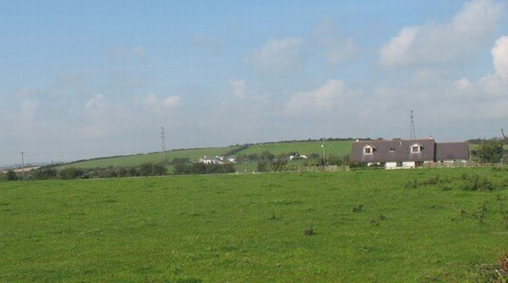 View across farmland towards Fadog Farmhouse and pylons Fadog Farm is the house below the pylons.