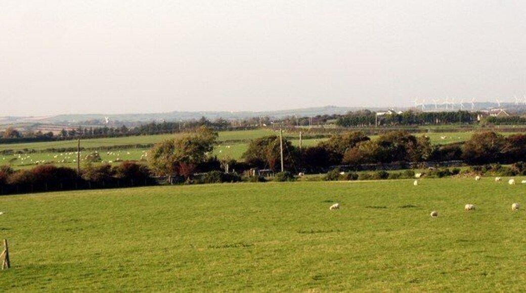 View northwards across farmland from the B5109 This image shows a considerable area of NW Anglesey. Melin Llynnon Mill at Llanddeusant can be seen background left, while in the background right, are the wind turbines north of Llyn Alaw.