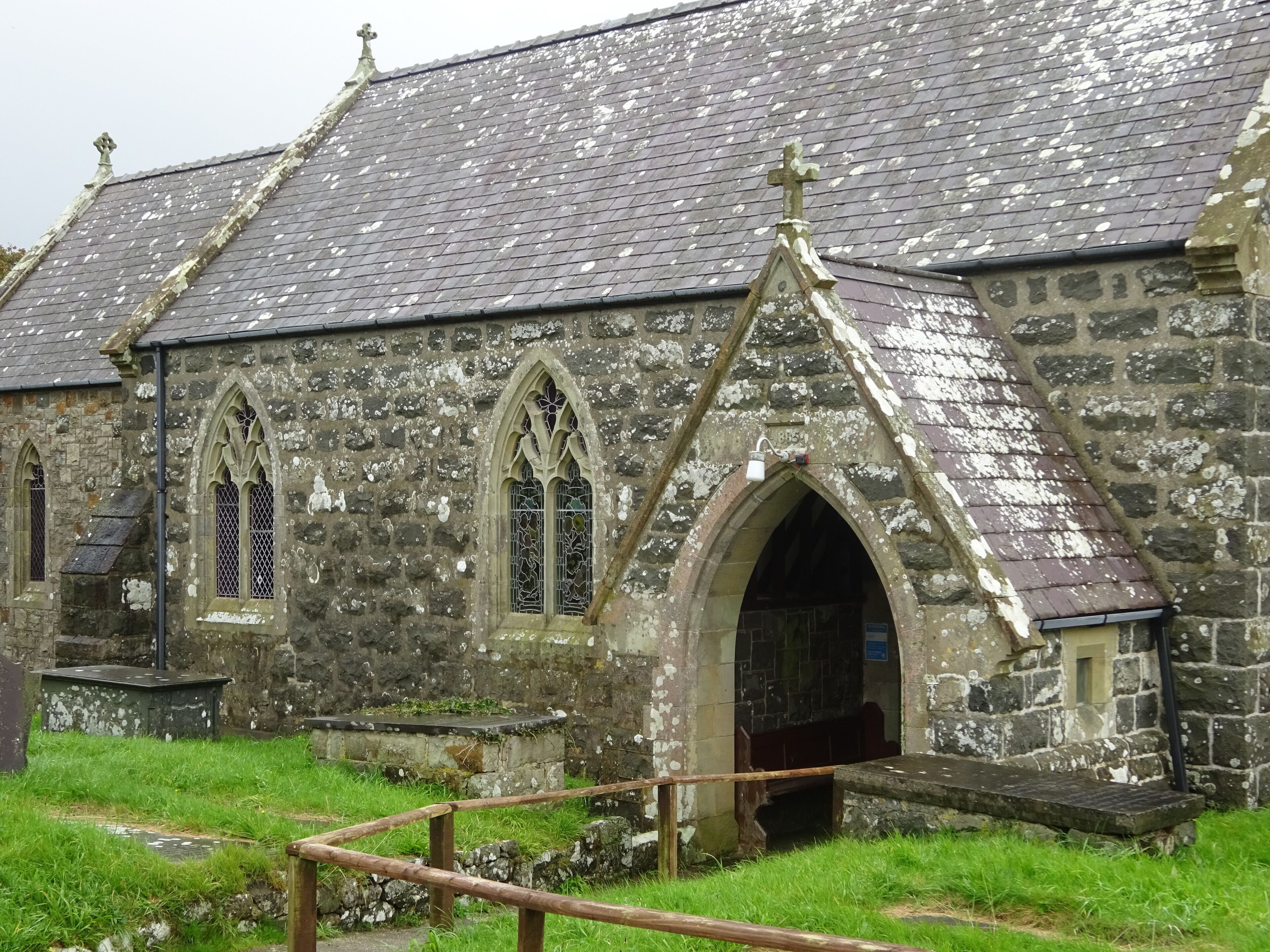 A historic stone church with pointed arches and a tiled roof.