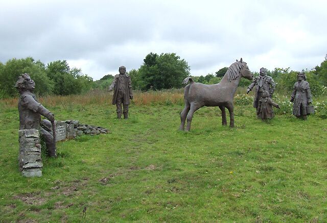 Roadside sculptures near Penuwch, Ceredigion This interesting group of sculptures is by B4577 near Penuwch. The accompanying plaque has become weathered and indistinct but Cered's image from 2005 states "A gift to the Community. The work of children of Ysgol Gynradd Penuwch.July 1993." What a pity the sapling planted by the old man on the bench has not thrived.
