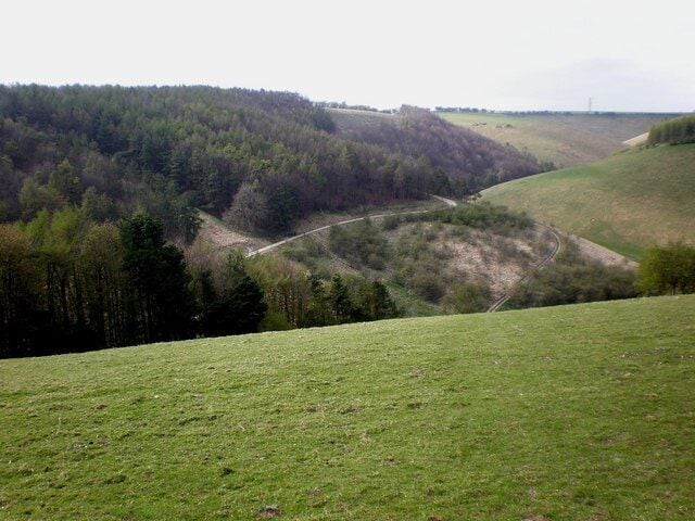 Deep Dale, Bishop Wilton, East Riding of Yorkshire, England. A panoramic view of the dry-valley complex taken from the track before it descends into the dale, with Manna Green on the right and the radio mast located on Garrowby Hill just visible on the skyline.
