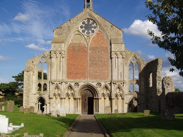 A Gothic-style church with a large rose window and arched windows.