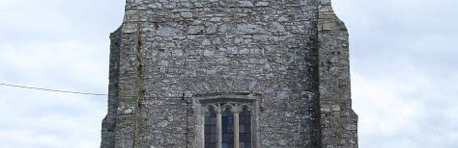 Tower of St Beuno's, Bettws Cedewain. Standing in a prominent position on the hill behind the New Inn 503766 the original church was founded by St Beuno in the 6th century. The present tower with its two stage timber belfry was built in the 1520s. For more details on the church see http://www.cpat.demon.co.uk/projects/longer/churches/montgom/16711.htm