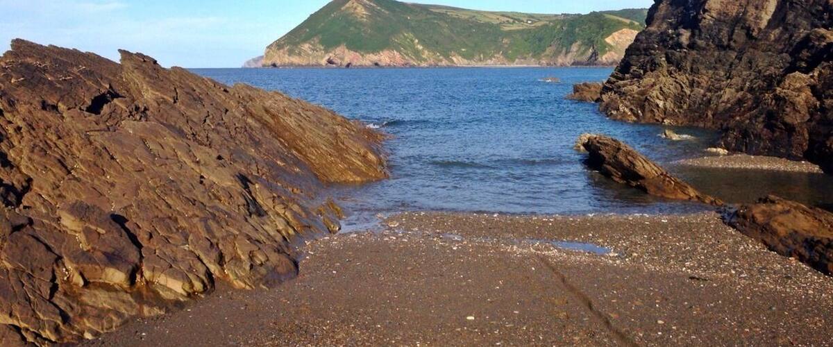 View of Little Hangman from sandbank at low tide at Broadsands Beach.