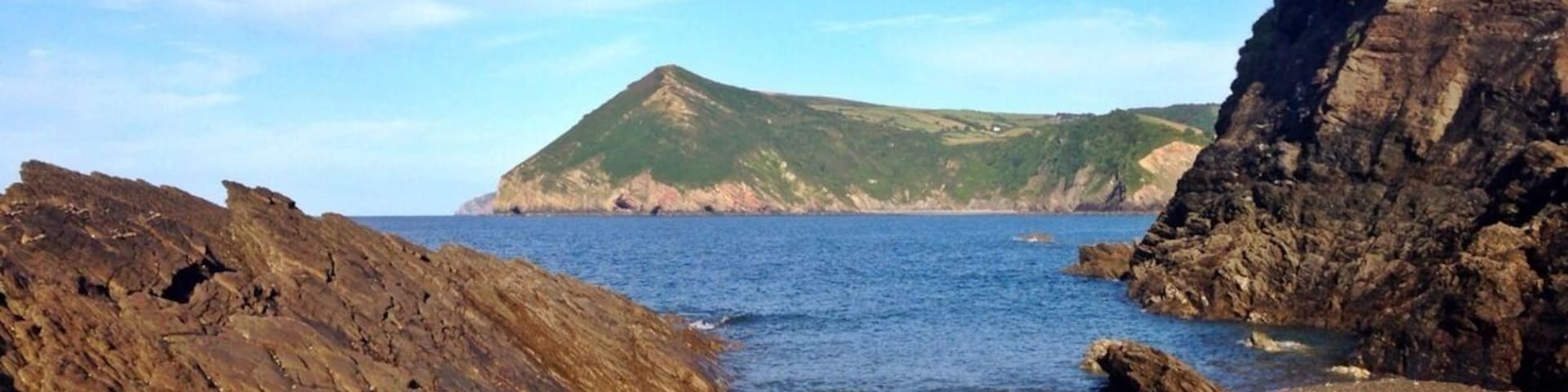 View of Little Hangman from sandbank at low tide at Broadsands Beach.