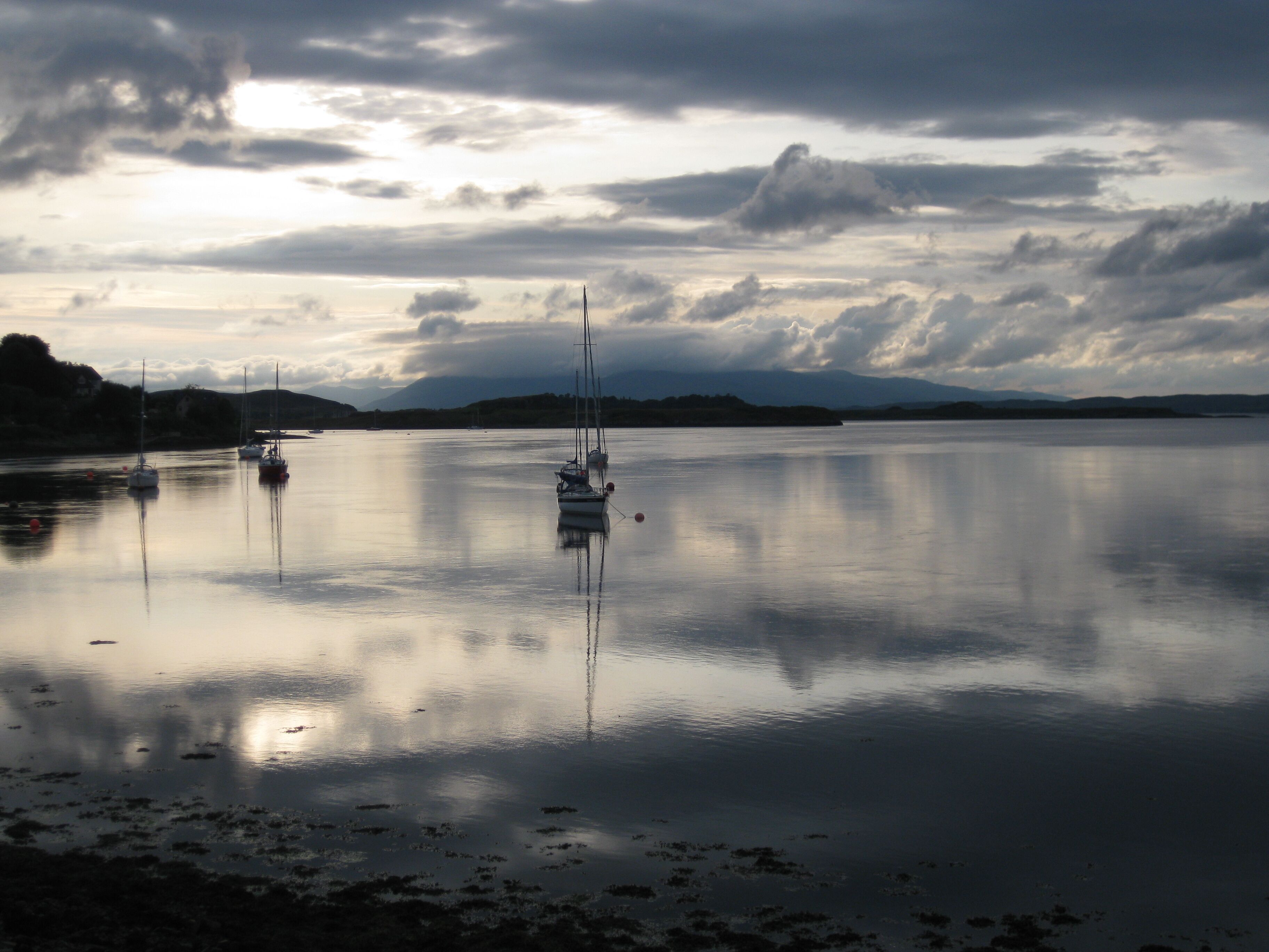 Moored Yachts Moored in bay near Connel Bridge. Island of Mull in the background.