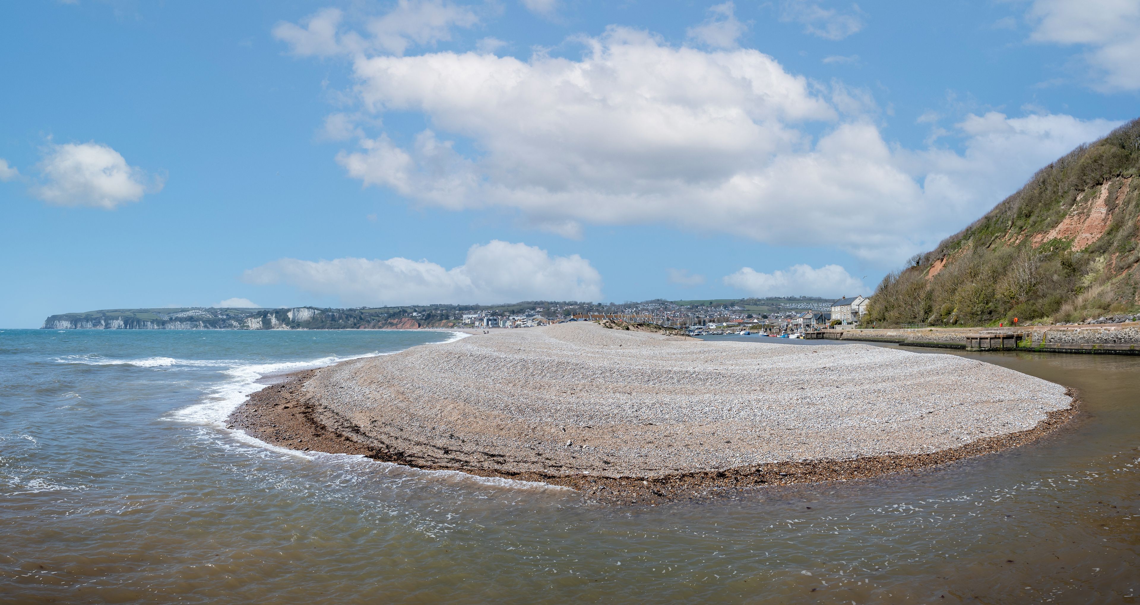 Panoramic view of U shaped entrance to Axmouth harbour with large spit of shingle