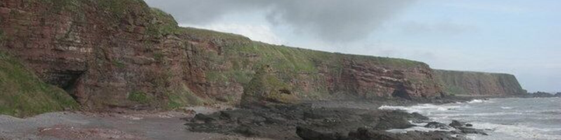 Maw Skellie, Auchmithie Wonderful name for the red sandstone cliff in the middle distance. Auchmithie was where the method for producing "smokies" was developed. The landowner forbad his serfs from leaving the village in case the secret method left with them.