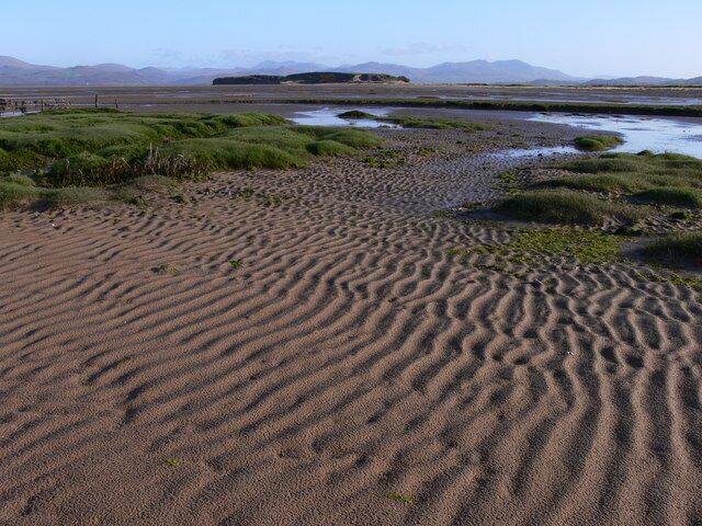 Dunnerholme. The Lake District mountains spread out on the horizon as a backdrop to Dunnerholme on the Duddon Estuary