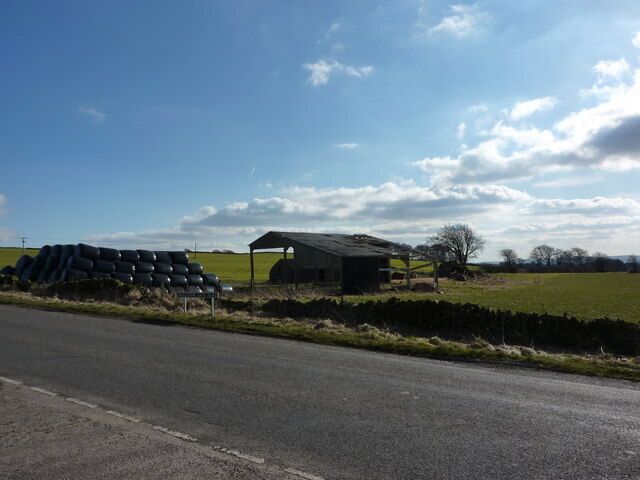 Silage bales and barn. The barn appears in575175, taken in 2007. It is looking a bit more forlorn now, but there are still bales stored next to it. The barns, which once stored hay,are of less use now that the silage is wrapped in plastic. The plastic may well end up polluting and littering the fields.