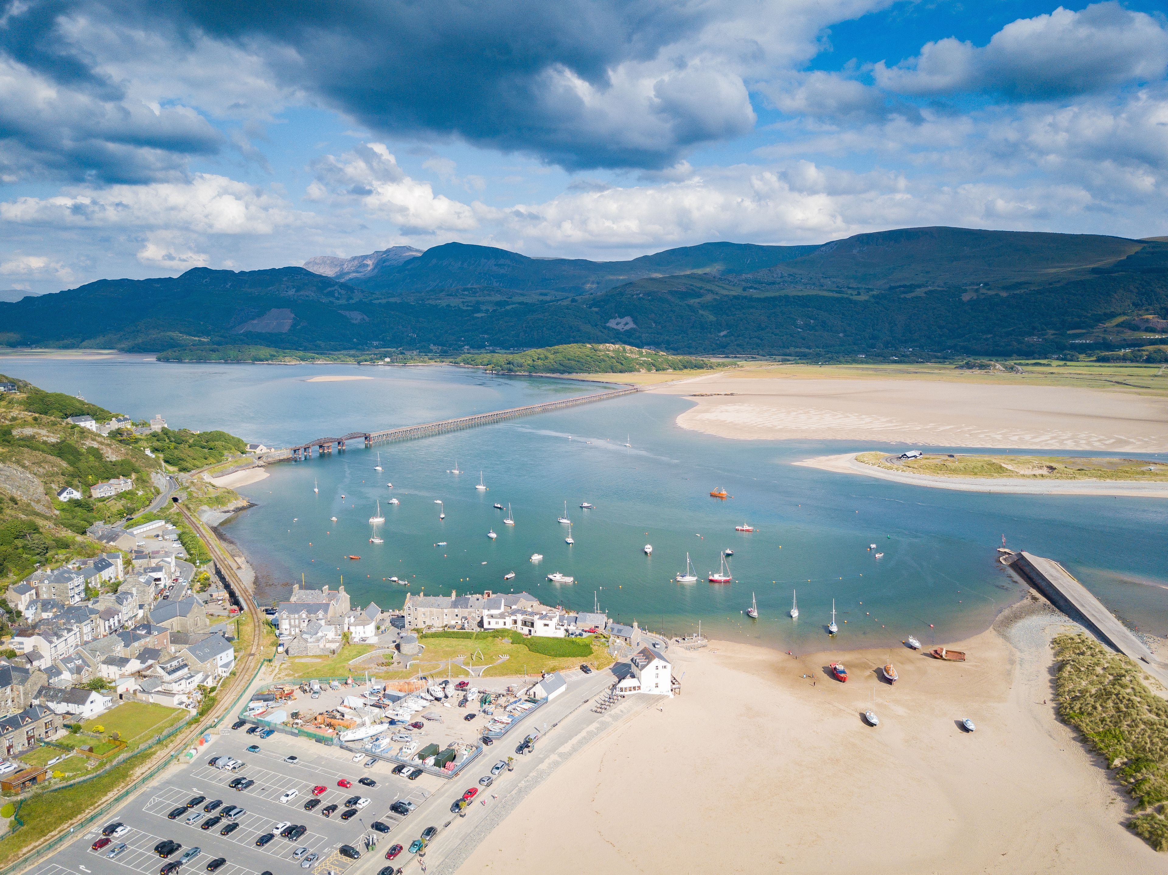 Aerial view of Barmouth Bridge and Afon Mawddach Estuary with Cadair Idris Mountains in background, Snowdonia, Wales, UK