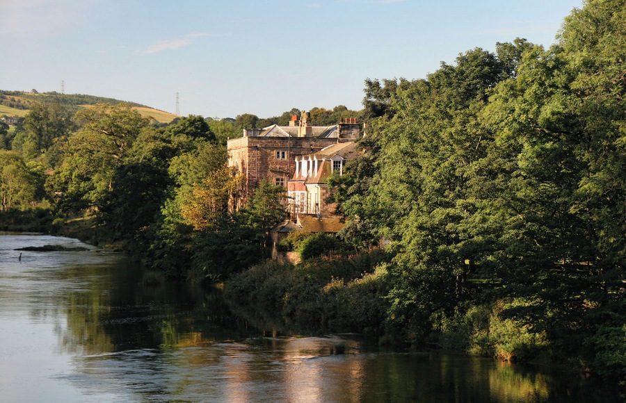Armathwaite Castle. View from Armathwaite Bridge looking up the River Eden to Armathwaite Castle.