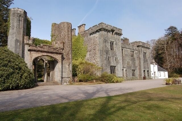 Armadale Castle The section on the left was built as a house at the end of the eighteenth century, and extended to be a castle in 1815. It was burnt down in 1855, and is today a sculptured ruin. The large section in the middle was built as a replacement, but was abandoned to the elements in 1925. The only section in use is the white painted building at the far right.