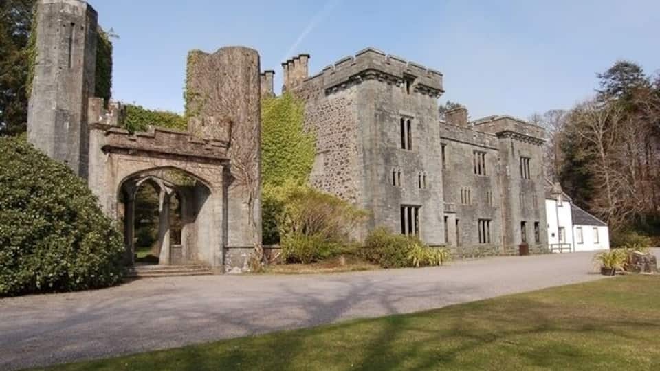 Armadale Castle The section on the left was built as a house at the end of the eighteenth century, and extended to be a castle in 1815. It was burnt down in 1855, and is today a sculptured ruin. The large section in the middle was built as a replacement, but was abandoned to the elements in 1925. The only section in use is the white painted building at the far right.